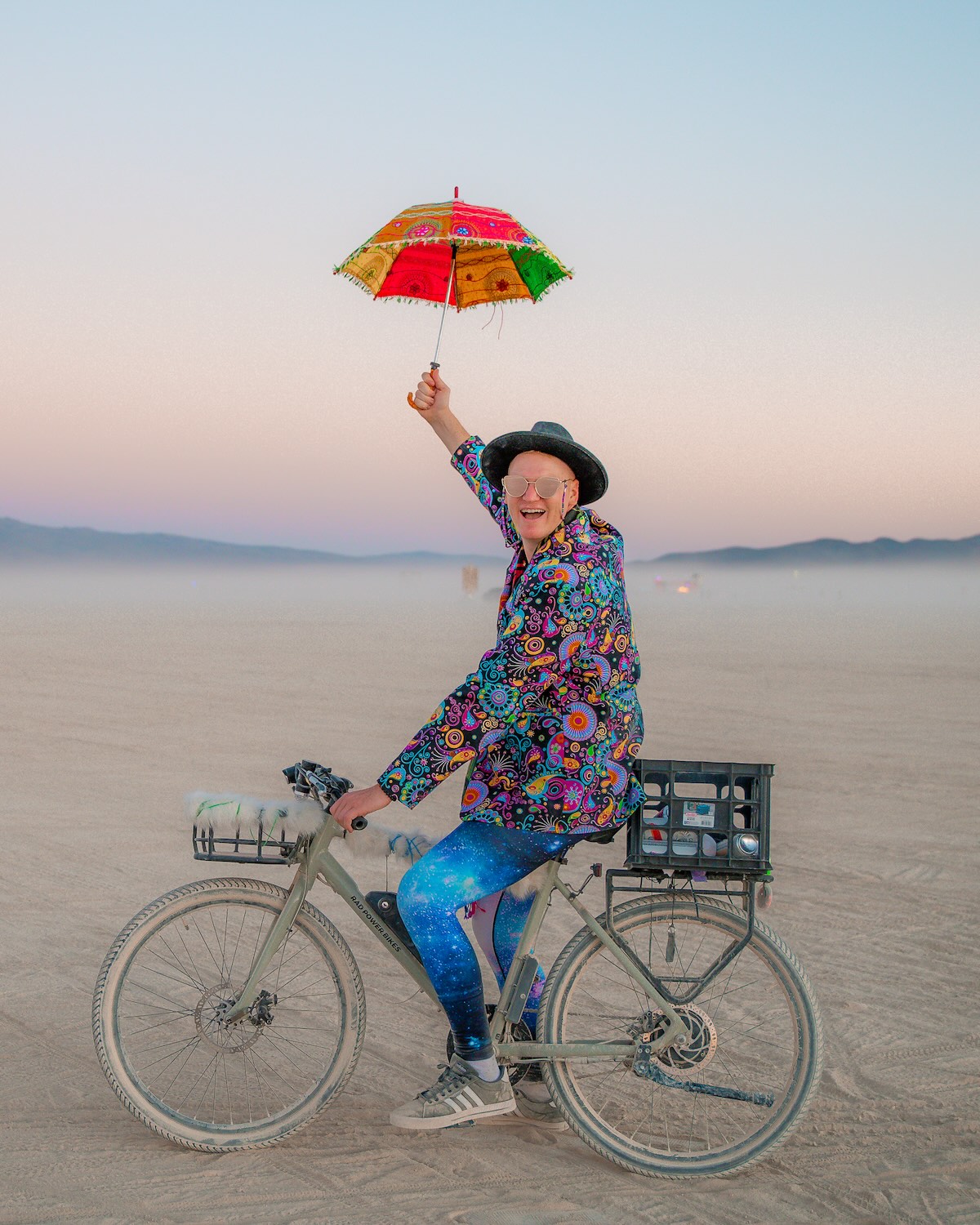 Man in fun outfit with parasol at Burning man